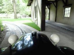 Cart with chickens and tunnel at the Oude Tufferbaan attraction at the Ruigrijk kingdom, viewed from an automobile