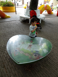 Max with an ice cream at a balancing game at the Kleuterhof playground at the Marerijk kingdom