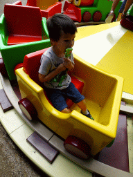 Max with a lollipop on the train at the Kleuterhof playground at the Marerijk kingdom