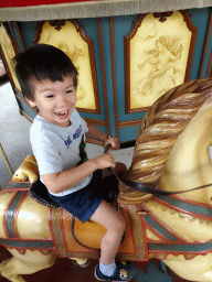 Max on a horse statue at the Anton Pieck Carousel at the Anton Pieck Plein square at the Marerijk kingdom