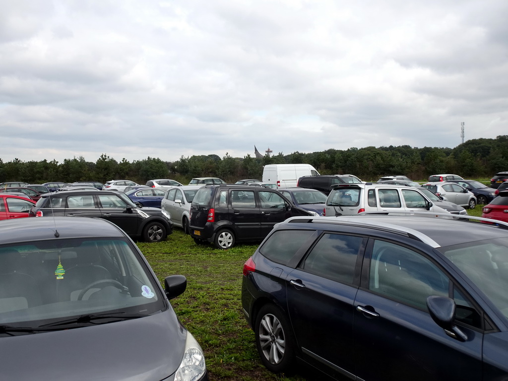 Temporary parking lot at the Dodenauweg street, with a view on the House of the Five Senses, the entrance to the Efteling theme park, and the Pagoda attraction at the Reizenrijk kingdom