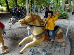 Max on a carousel at the Kindervreugd playground at the Marerijk kingdom