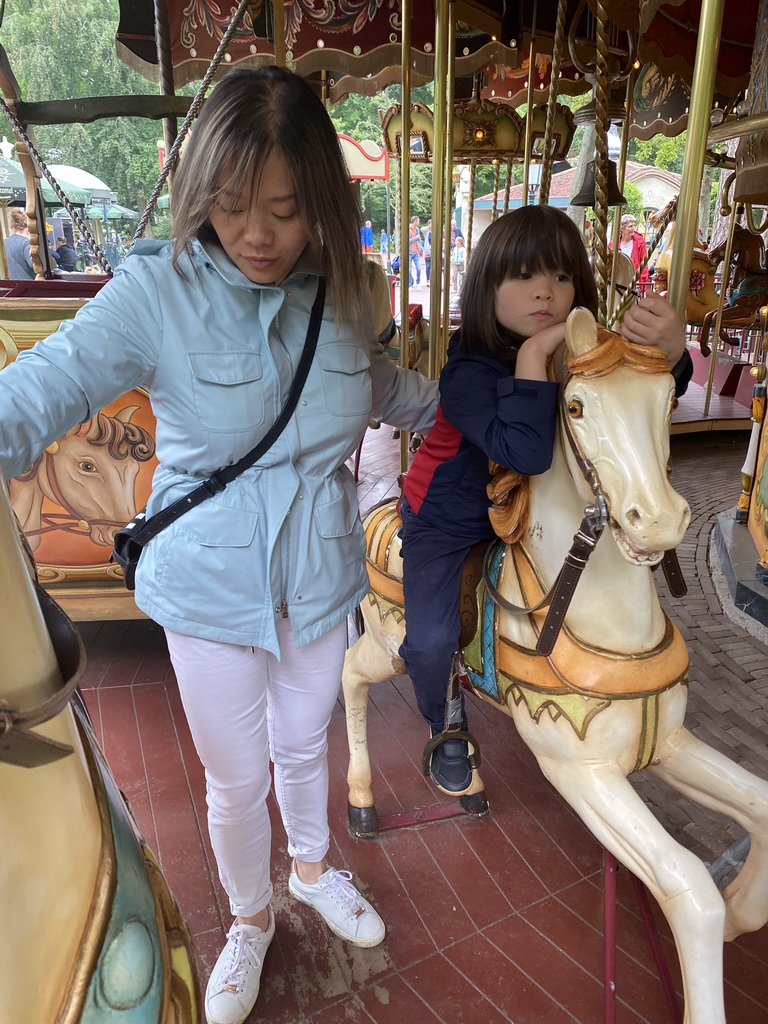 Miaomiao and Max on a horse statue at the Vermolen Carousel at the Anton Pieck Plein square at the Marerijk kingdom