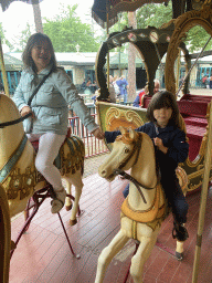 Miaomiao and Max on a horse statue at the Vermolen Carousel at the Anton Pieck Plein square at the Marerijk kingdom