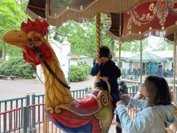 Miaomiao and Max on a rooster statue at the Vermolen Carousel at the Anton Pieck Plein square at the Marerijk kingdom