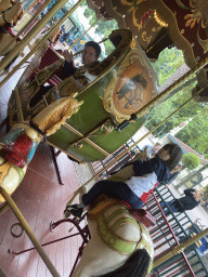 Tim and Max on a horse statue at the Vermolen Carousel at the Anton Pieck Plein square at the Marerijk kingdom