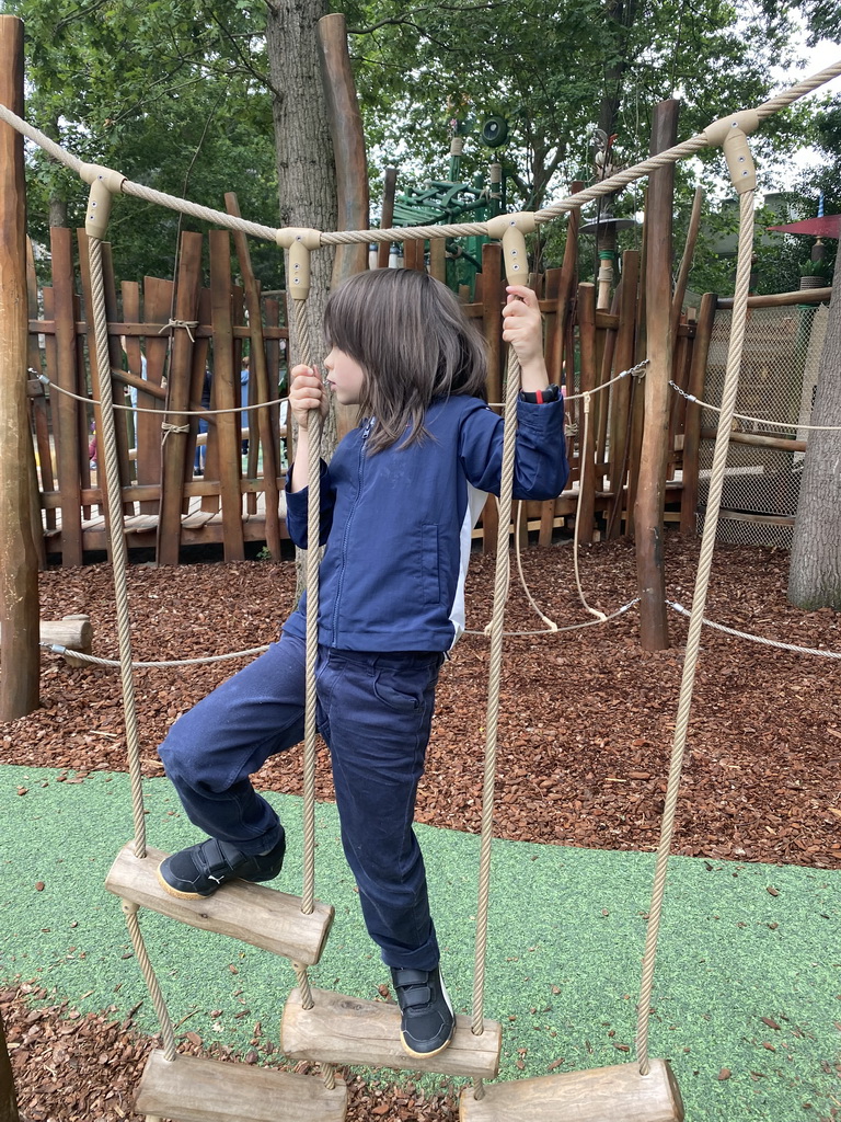 Max on a rope bridge at the Nest! play forest at the Ruigrijk kingdom