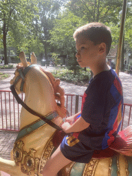 Max on a horse statue at the Vermolen Carousel at the Anton Pieck Plein square at the Marerijk kingdom