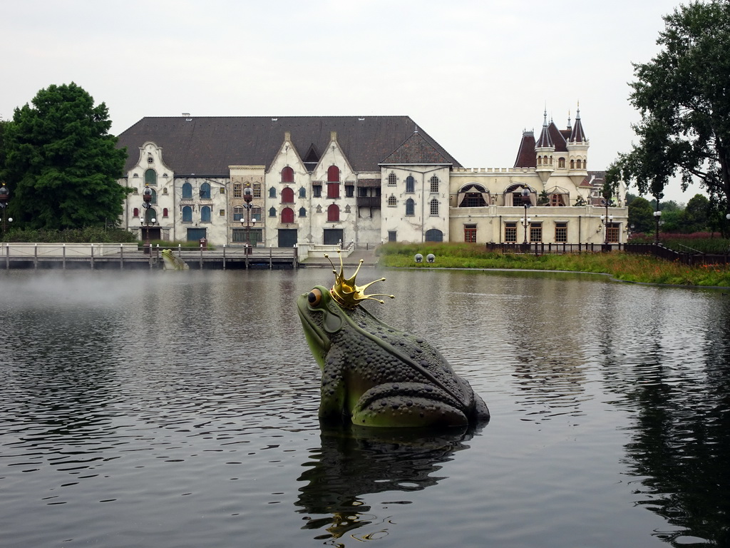 Frog statue at the Aquanura lake and the Efteling Theatre at the Anderrijk kingdom