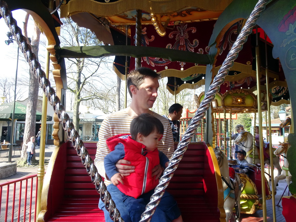 Tim and Max at the carrousel at the Anton Pieck Plein square at the Marerijk kingdom