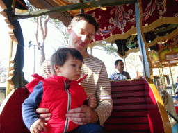 Tim and Max at the carrousel at the Anton Pieck Plein square at the Marerijk kingdom