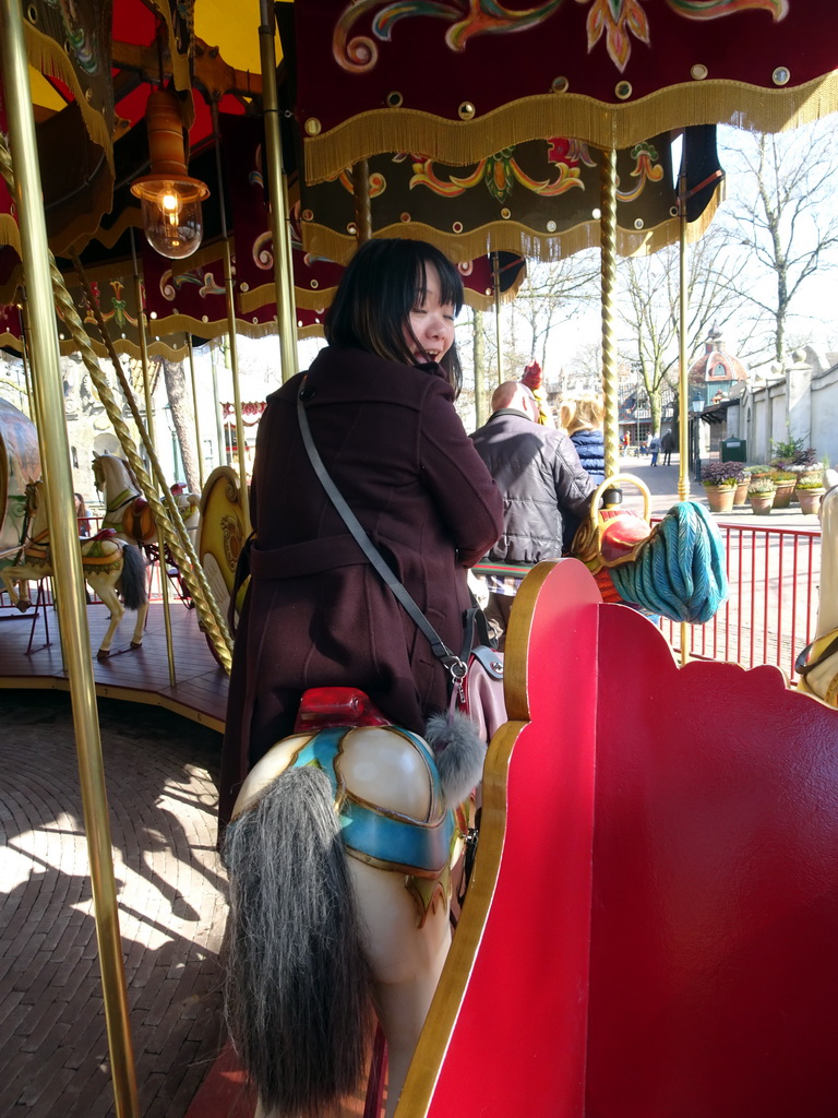 Miaomiao at the carrousel at the Anton Pieck Plein square at the Marerijk kingdom