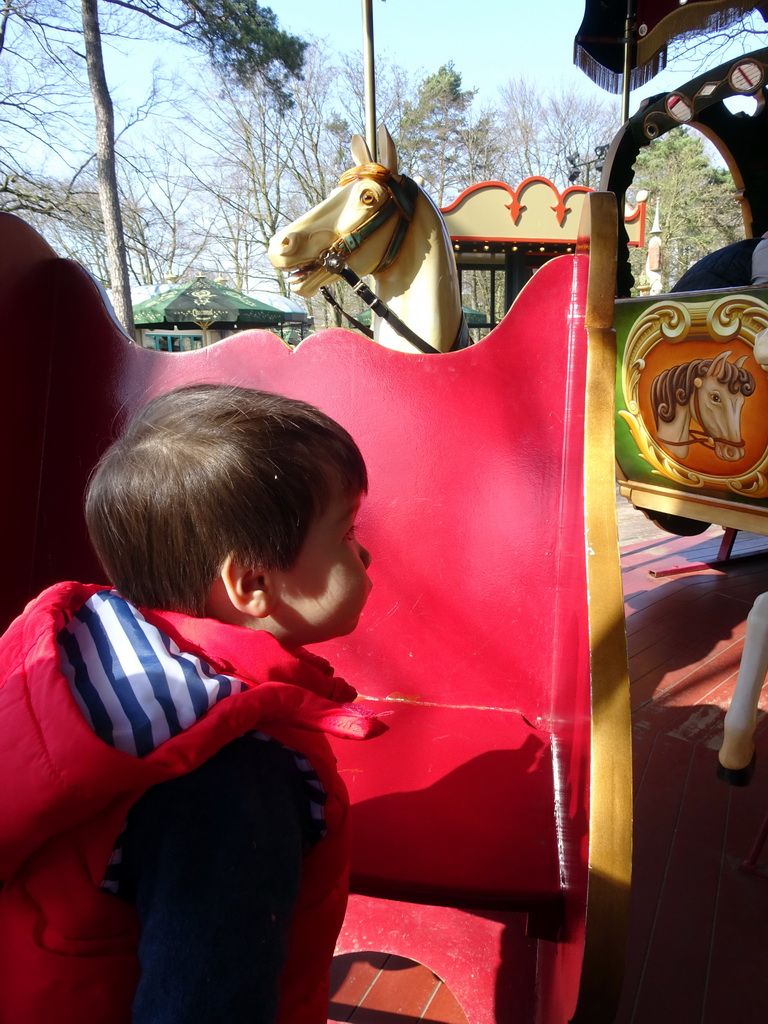 Max at the carrousel at the Anton Pieck Plein square at the Marerijk kingdom