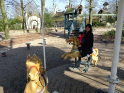 Miaomiao and Max on a carrousel at the Kindervreugd playground at the Marerijk kingdom
