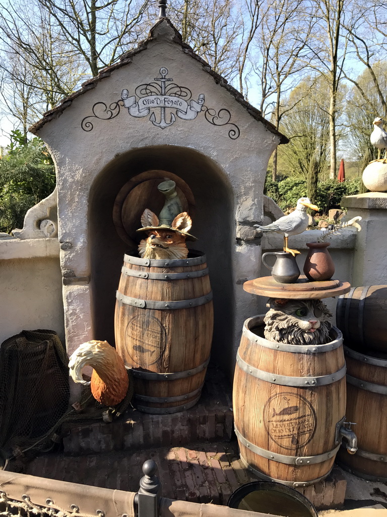 Wooden barrels, fox, cat and bird at the Pinocchio attraction at the Fairytale Forest at the Marerijk kingdom