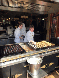 People making Poffertjes at the `t Poffertje restaurant at the Anton Pieck Plein square at the Marerijk kingdom