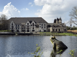 Frog statue at the Aquanura lake and the Efteling Theatre at the Anderrijk kingdom, viewed from the train