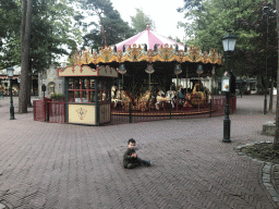 Max in front of the Vermolen Carousel at the Anton Pieck Plein square at the Marerijk kingdom