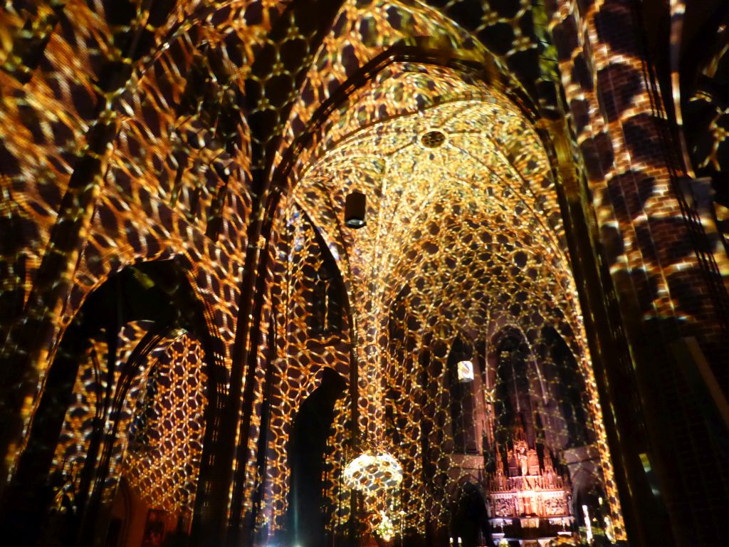 Nave and apse of the Augustijnenkerk church during the Casa Magica lightshow of the GLOW festival