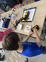 Max playing with a robot arm at the Strip area at the High Tech Campus Eindhoven, during the High Tech Campus Eindhoven Open Day 2022