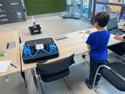 Max playing with a robot at the Conference Centre at the Strip area at the High Tech Campus Eindhoven, during the High Tech Campus Eindhoven Open Day 2022