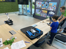 Max playing with a robot at the Conference Centre at the Strip area at the High Tech Campus Eindhoven, during the High Tech Campus Eindhoven Open Day 2022