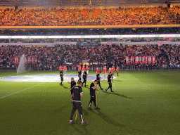 Groundskeepers and stewards on the pitch at the Philips Stadium, viewed from the Eretribune Noord grandstand, just before the football match PSV - NEC