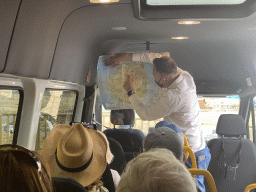 Our tour guide explaining the route of the Gran Canaria Highlights Tour in the tour bus on the parking lot of the Aloe Vera farm
