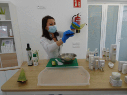 Employee showing Aloe Vera juice at the main building of the Aloe Vera farm