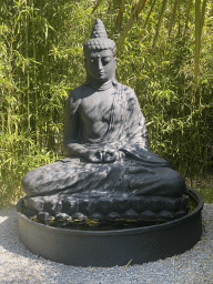 Buddha statue at the Bamboo Garden at the exotic garden center De Evenaar
