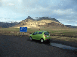 Miaomiao with the rental car at the Raufarfellsvegur road, and the Eyjafjallajökull volcano