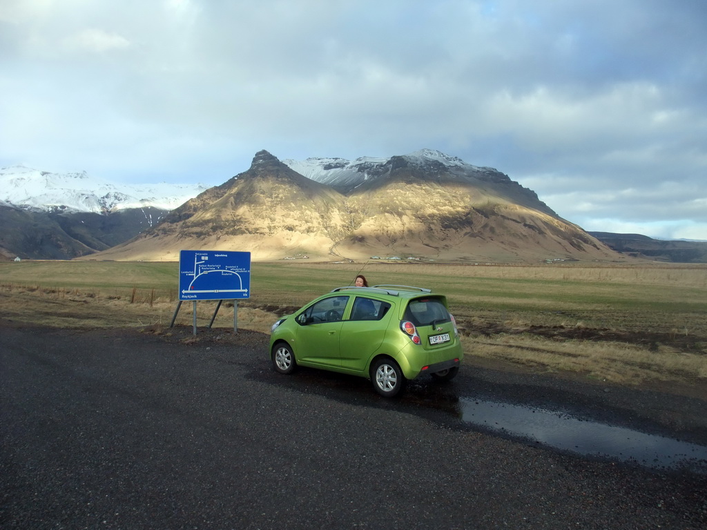 Miaomiao with the rental car at the Raufarfellsvegur road, and the Eyjafjallajökull volcano