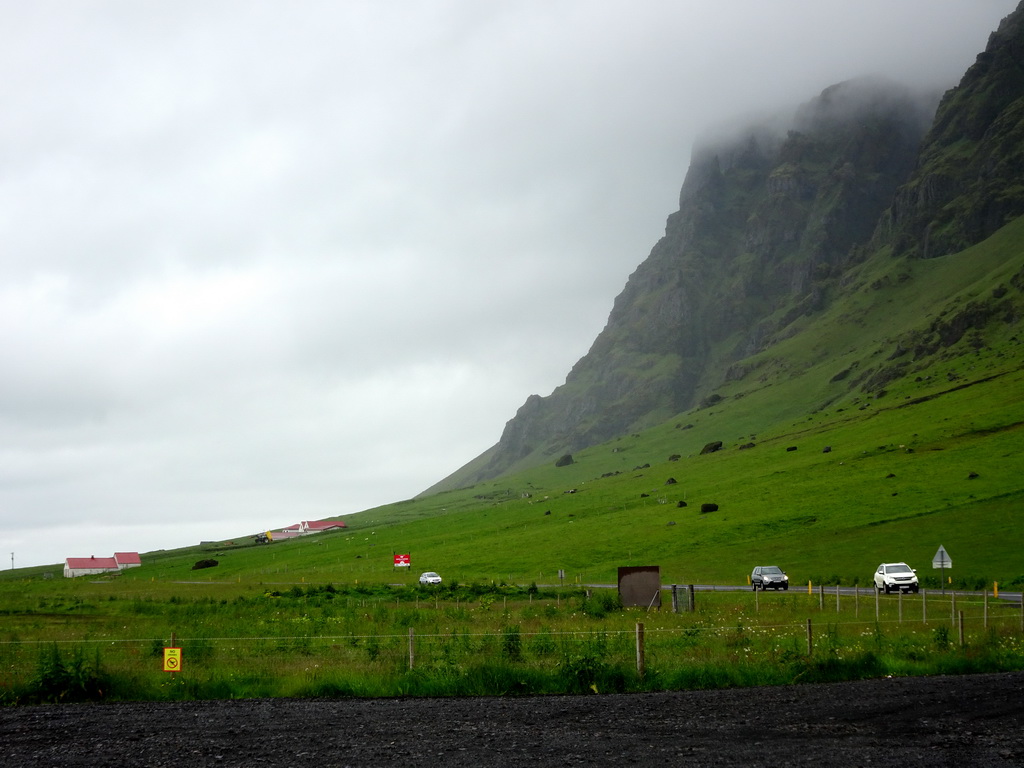 The Steinar farm, the Hringvegur road and a mountain on the southwest side of the Eyjafjallajökull volcano, viewed from the parking lot of the Þorvaldseyri visitor centre
