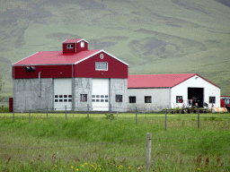 Buildings of the Þorvaldseyri farm in front of the Eyjafjallajökull volcano, viewed from the parking lot of the Þorvaldseyri visitor centre