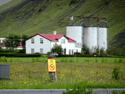 Buildings of the Þorvaldseyri farm in front of the Eyjafjallajökull volcano, viewed from the parking lot of the Þorvaldseyri visitor centre