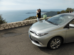 Miaomiao and Max at our rental car at a parking place along the Moyenne Corniche road from Nice, with a view on the east side of the Cap-Ferrat peninsula