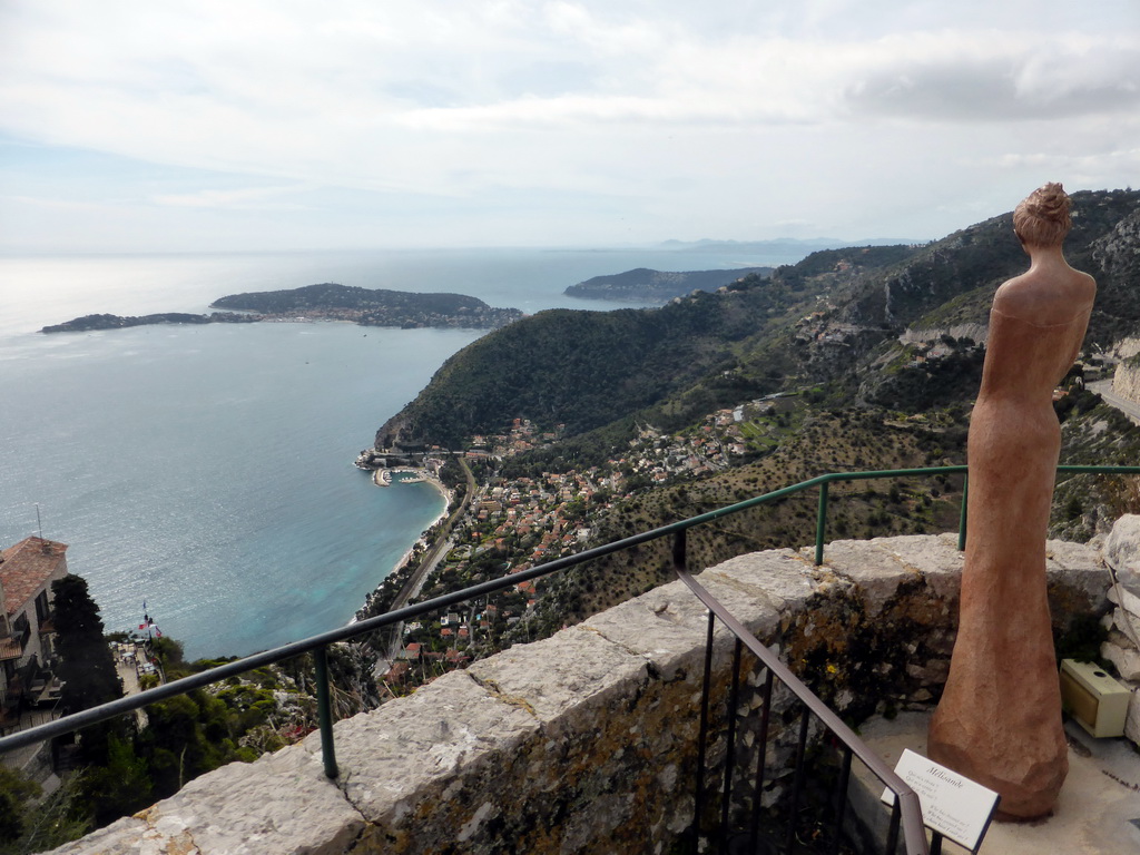 Statue at the castle ruins at the Jardin d`Èze botanical garden, with a view on the town of Èze-sur-Mer, the Mont Boron hill and the Cap-Ferrat peninsula with the town of Saint-Jean-Cap-Ferrat