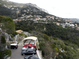 Expensive cars at the Château de La Chèvre d`Or hotel, viewed from the Place du Centenaire square