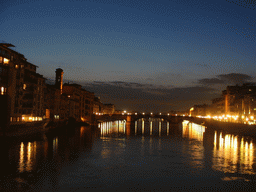 The Ponte Santa Trinita bridge over the Arno river and the tower of the Chiesa di San Jacopo Soprarno church, viewed from the Ponte Vecchio bridge, by night