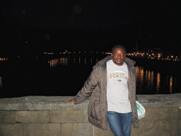 Miaomiao`s friend at the Ponte Vecchio bridge, with a view on the Ponte Santa Trinita bridge over the Arno river and the tower of the Chiesa di San Jacopo Soprarno church, by night