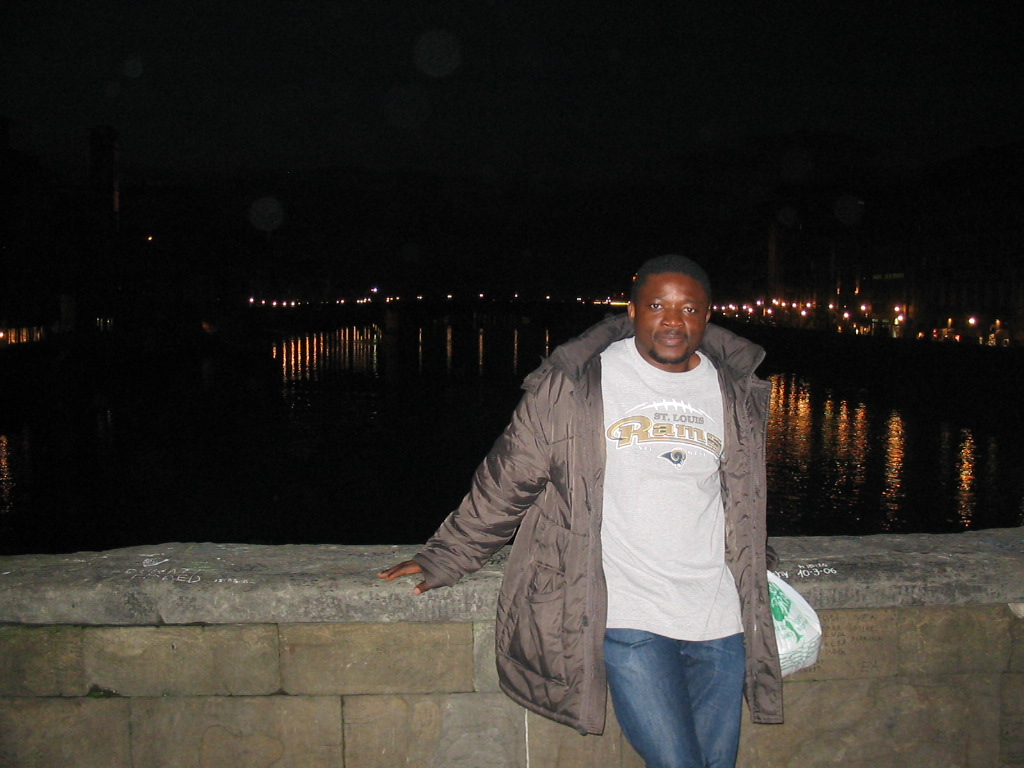 Miaomiao`s friend at the Ponte Vecchio bridge, with a view on the Ponte Santa Trinita bridge over the Arno river and the tower of the Chiesa di San Jacopo Soprarno church, by night