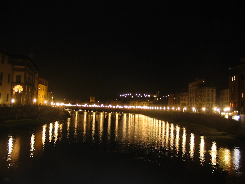 The Ponte alle Grazie bridge over the Arno river, viewed from the Ponte Vecchio bridge, by night