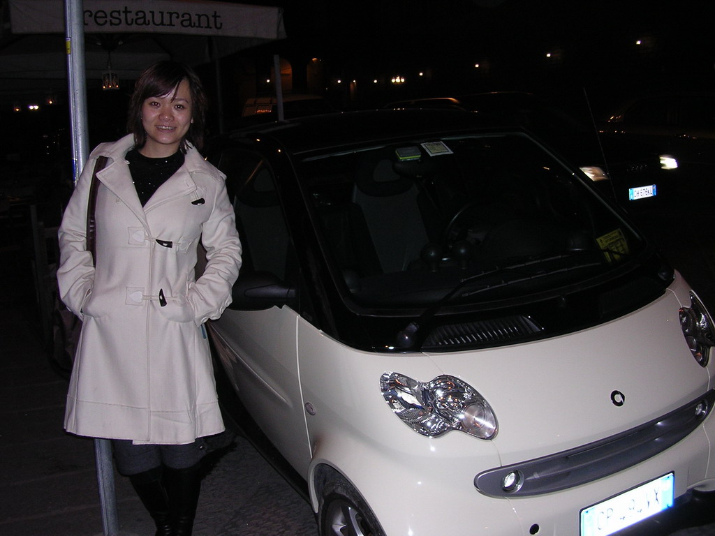 Miaomiao with a small car in the city center, by night