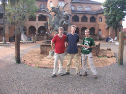 Tim, his friends and a statue in front of the Foumban Royal Palace