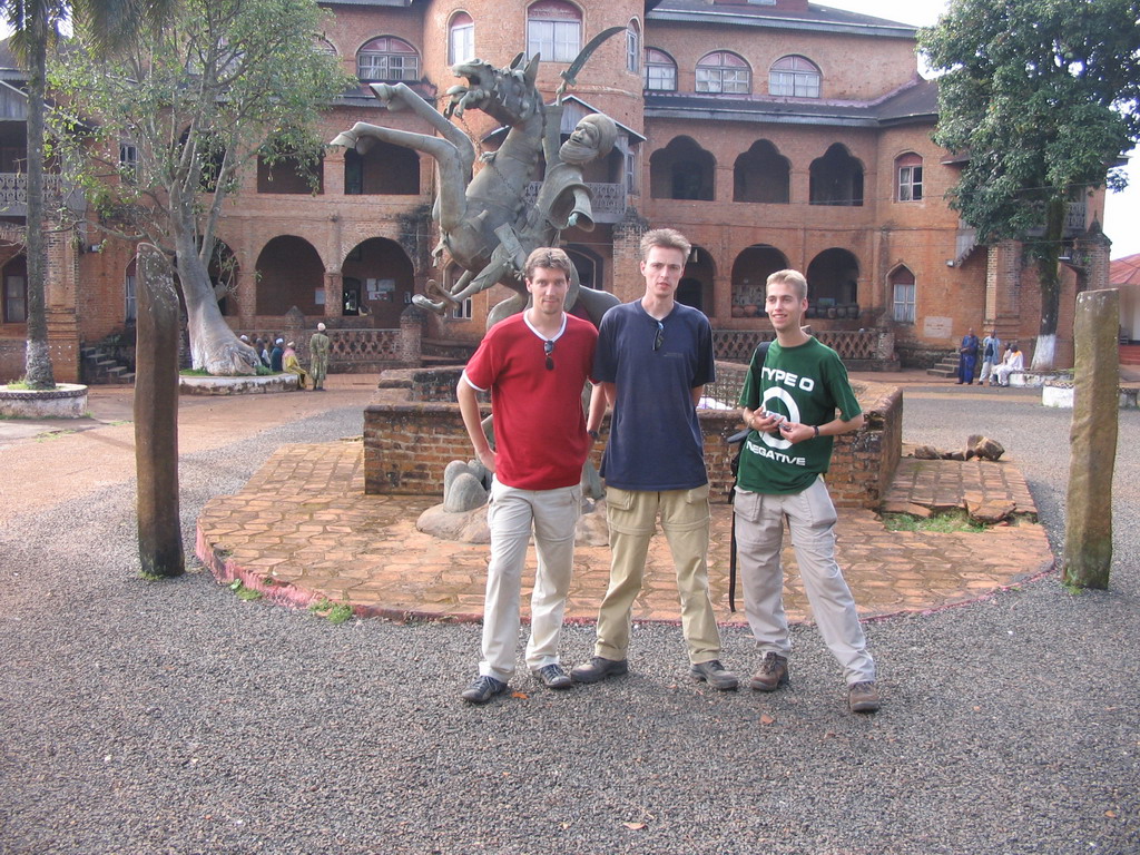 Tim, his friends and a statue in front of the Foumban Royal Palace