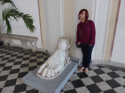 Miaomiao with a statue of Hermes` sandal at the entrance hall of the Royal Palace