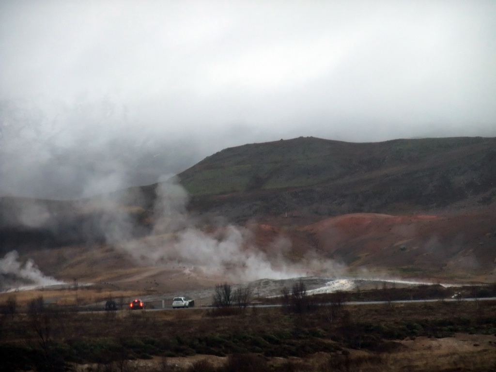 Several geysers at the Geysir geothermal area, viewed from the car from Gullfoss to Reykjavik