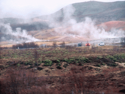 Several geysers at the Geysir geothermal area, viewed from the car from Gullfoss to Reykjavik