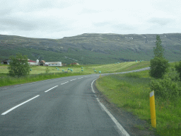 The Laugarvatnsvegur road, farm and mountains, viewed from the rental car on the Laugarvatnsvegur road