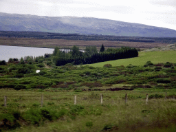 The Apavatn lake, grassland and mountains, viewed from the rental car on the Laugarvatnsvegur road to Selfoss